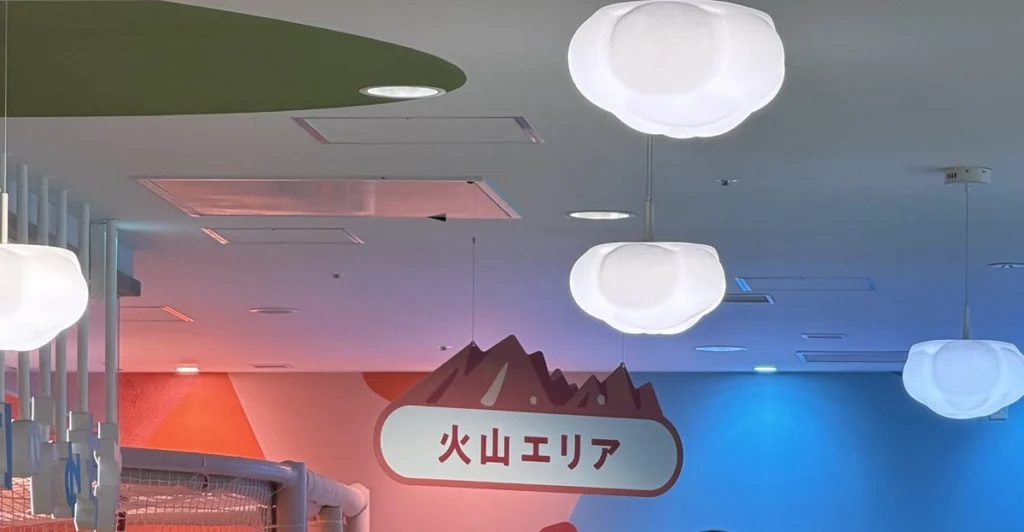 火山エリアの看板と赤いネットの遊具